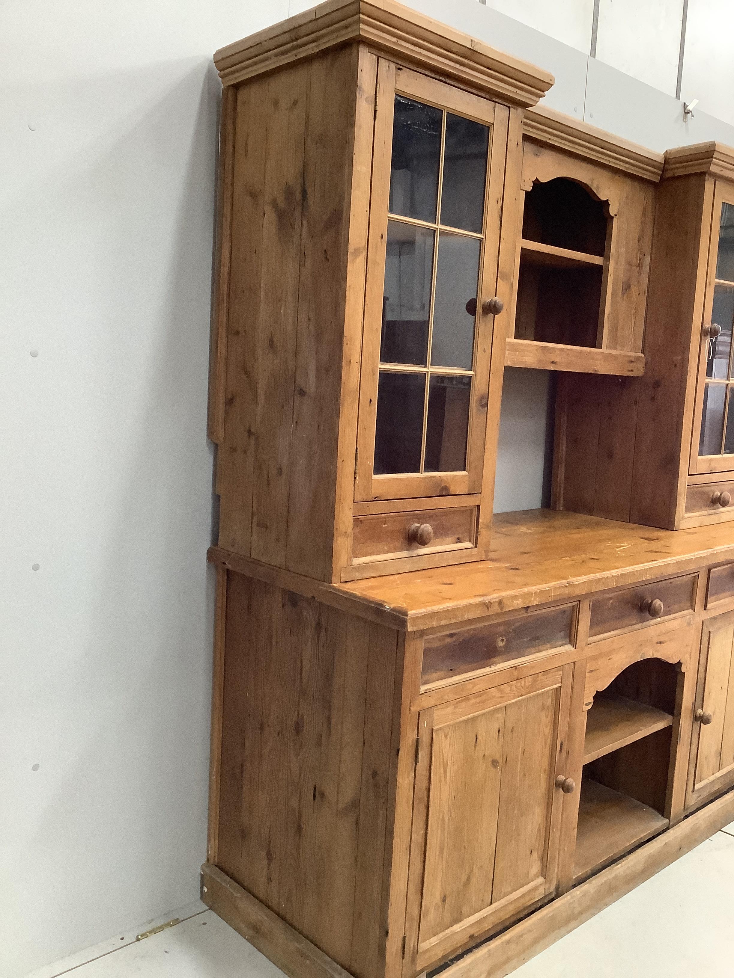 A Victorian style pine dresser with glazed cupboards, width 186cm, depth 68cm, height 203cm